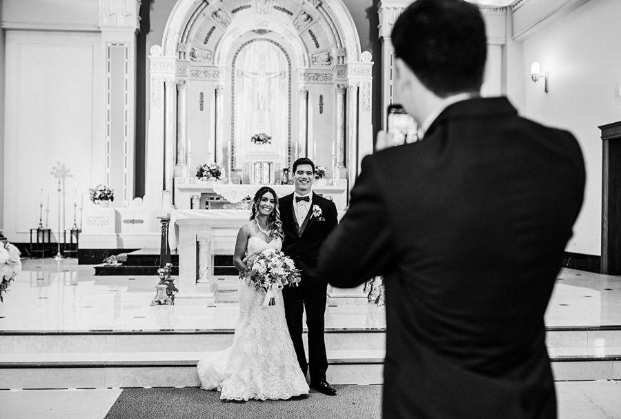 Candid portrait of best man taking bride and groom's portrait inside St. Raphael the Archangel church ‖ Hazel + Skye » http://www.hazelandskye.com